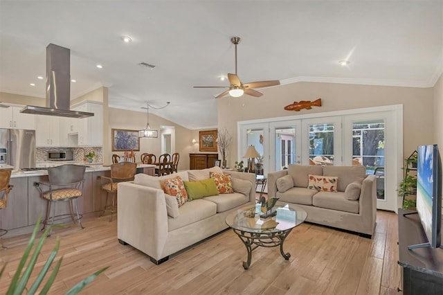 living room with crown molding, vaulted ceiling, visible vents, and light wood-type flooring