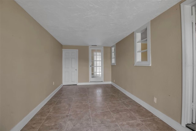 1830 Virginia Dr, Bradenton, FL 34205 - foyer with tile patterned floors, a textured ceiling, and baseboards