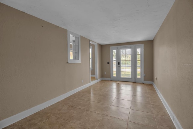 1830 Virginia Dr, Bradenton, FL 34205 - interior space with a textured wall, baseboards, and light tile patterned floors