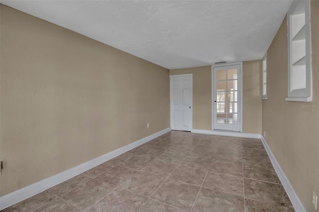 1830 Virginia Dr, Bradenton, FL 34205 - empty room with baseboards and tile patterned flooring