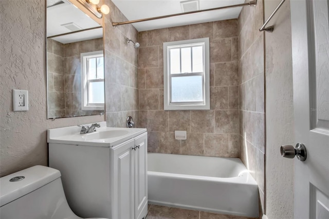 1830 Virginia Dr, Bradenton, FL 34205 - bathroom with vanity, toilet, a textured wall, and plenty of natural light
