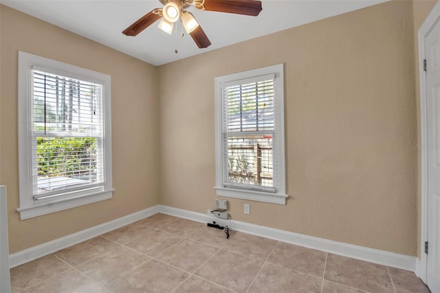 1830 Virginia Dr, Bradenton, FL 34205 - empty room with light tile patterned flooring, baseboards, and a ceiling fan