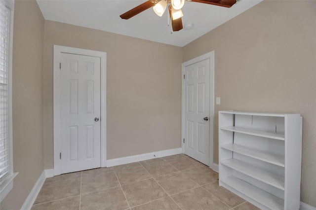 1830 Virginia Dr, Bradenton, FL 34205 - unfurnished bedroom featuring ceiling fan, baseboards, and light tile patterned floors