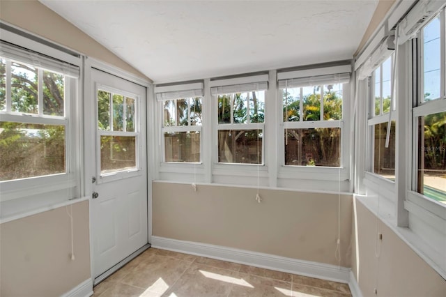1830 Virginia Dr, Bradenton, FL 34205 - unfurnished sunroom featuring tile patterned floors, a wealth of natural light, vaulted ceiling, and baseboards