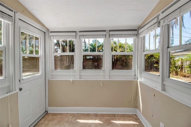 1830 Virginia Dr, Bradenton, FL 34205 - unfurnished sunroom with baseboards, plenty of natural light, and vaulted ceiling