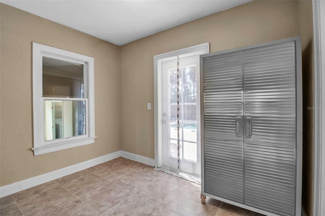 1830 Virginia Dr, Bradenton, FL 34205 - doorway with baseboards and light tile patterned floors