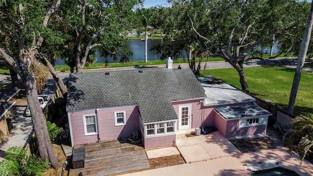 1830 Virginia Dr, Bradenton, FL 34205 - rear view of property with a water view, a tiled roof, and a lawn