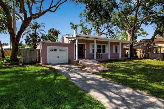 1830 Virginia Dr, Bradenton, FL 34205 - view of front of property with a chimney, fence, an attached garage, a porch, and a front lawn