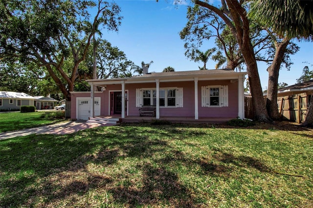 1830 Virginia Dr, Bradenton, FL 34205 - ranch-style house with covered porch, a front lawn, an attached garage, and fence