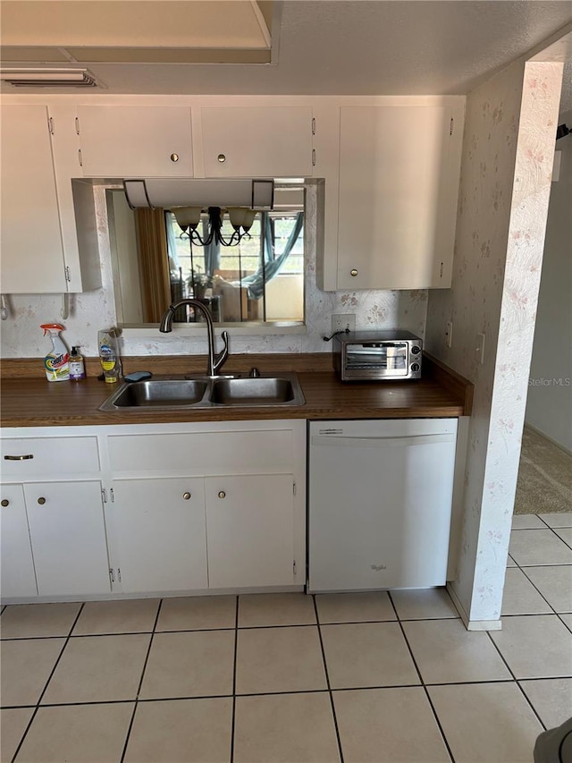 2808 60th Ave W Unit 1924, Bradenton, FL 34207 - kitchen with a toaster, dishwasher, a sink, white cabinetry, and dark countertops