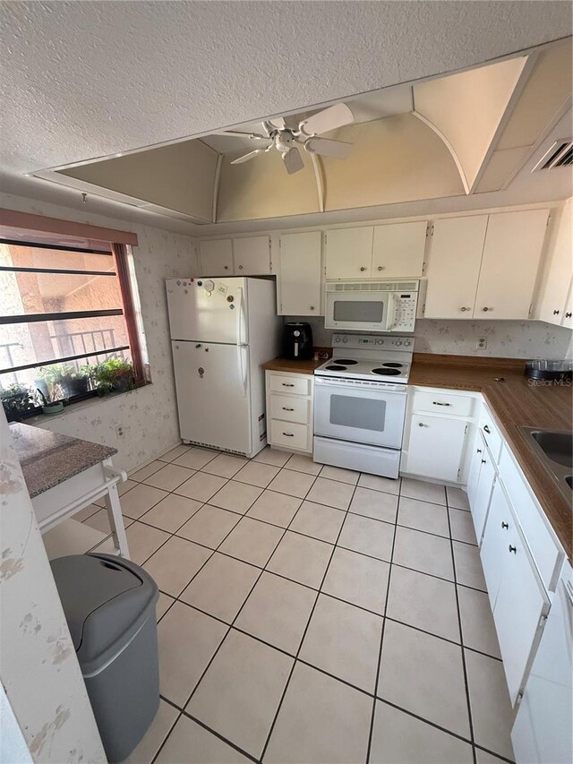 2808 60th Ave W Unit 1924, Bradenton, FL 34207 - kitchen with white appliances, wallpapered walls, a textured ceiling, light tile patterned floors, and ceiling fan