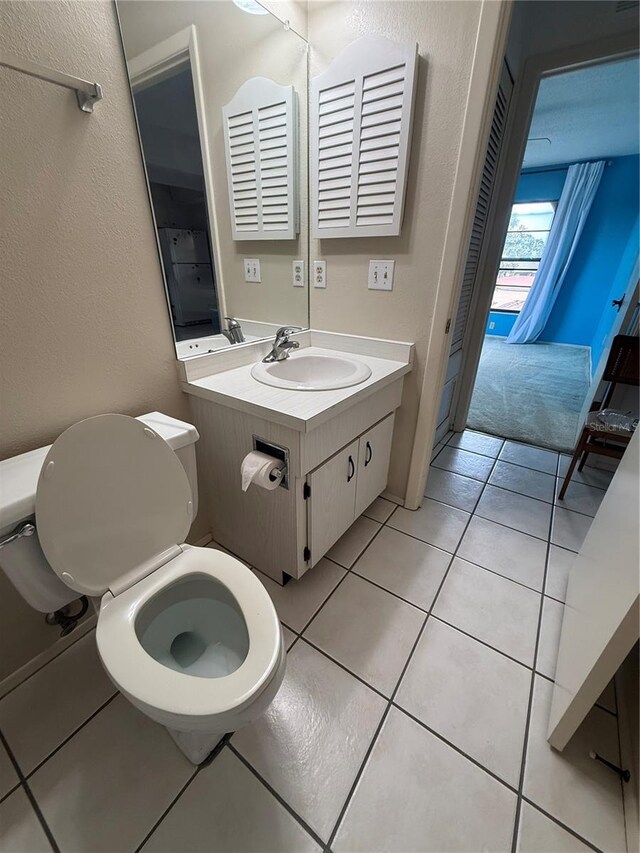 2808 60th Ave W Unit 1924, Bradenton, FL 34207 - half bath with toilet, vanity, a textured wall, and tile patterned flooring