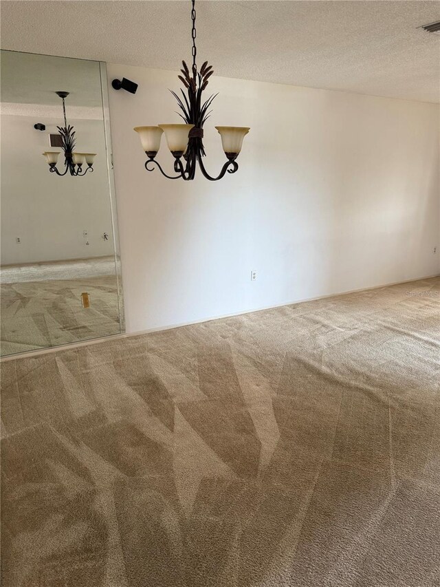 2808 60th Ave W Unit 1924, Bradenton, FL 34207 - carpeted empty room with a textured ceiling and a chandelier