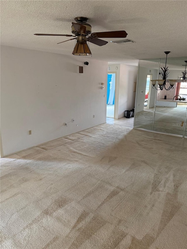 2808 60th Ave W Unit 1924, Bradenton, FL 34207 - unfurnished living room featuring carpet floors, a textured ceiling, ceiling fan, and a chandelier