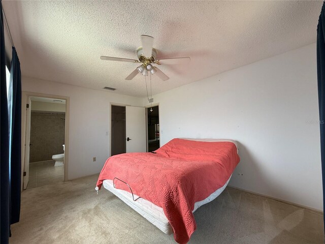 2808 60th Ave W Unit 1924, Bradenton, FL 34207 - bedroom with light carpet, connected bathroom, a textured ceiling, a ceiling fan, and a closet