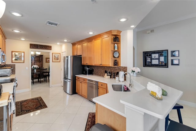 kitchen featuring a sink, appliances with stainless steel finishes, open shelves, a peninsula, and a chandelier