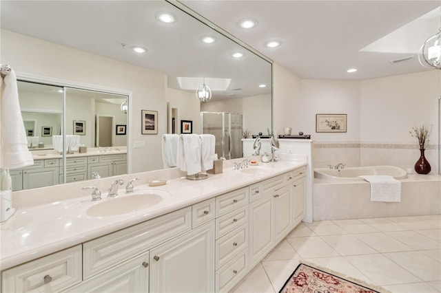bathroom with a stall shower, double vanity, tile patterned flooring, a bath, and recessed lighting