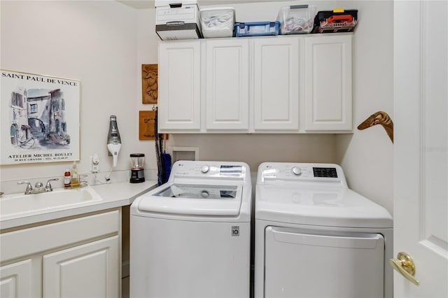 clothes washing area with washer and clothes dryer and cabinet space