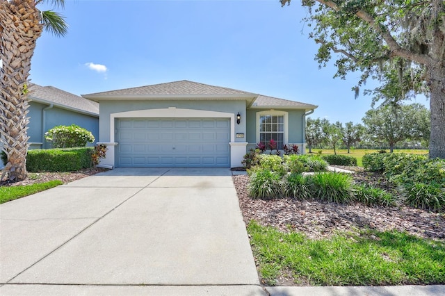 view of front of property with a garage, stucco siding, and driveway