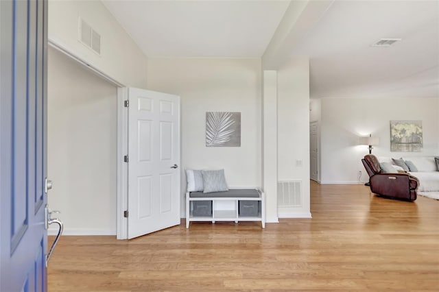 entrance foyer featuring light wood-style floors, baseboards, and visible vents