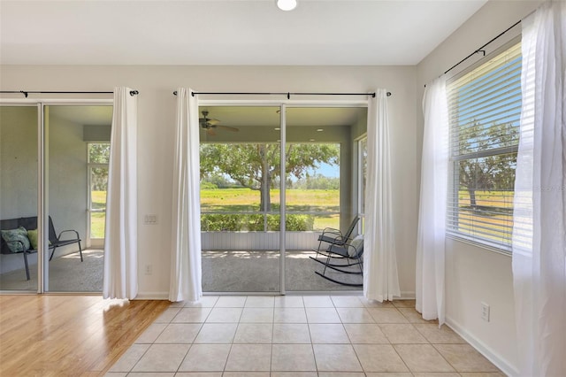 doorway to outside featuring baseboards