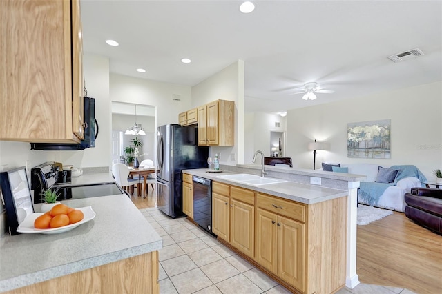 kitchen with a sink, light brown cabinets, open floor plan, visible vents, and black appliances