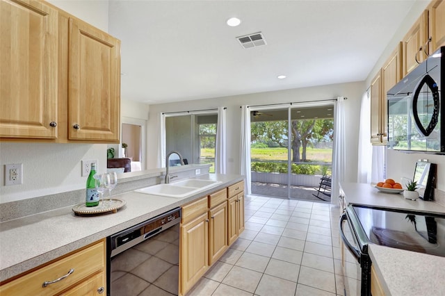 kitchen featuring visible vents, a sink, black appliances, and light brown cabinets