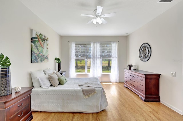 bedroom featuring baseboards, ceiling fan, and light wood-type flooring