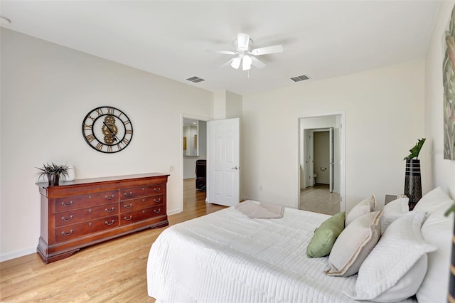 bedroom featuring visible vents, a ceiling fan, light wood-style floors, and baseboards