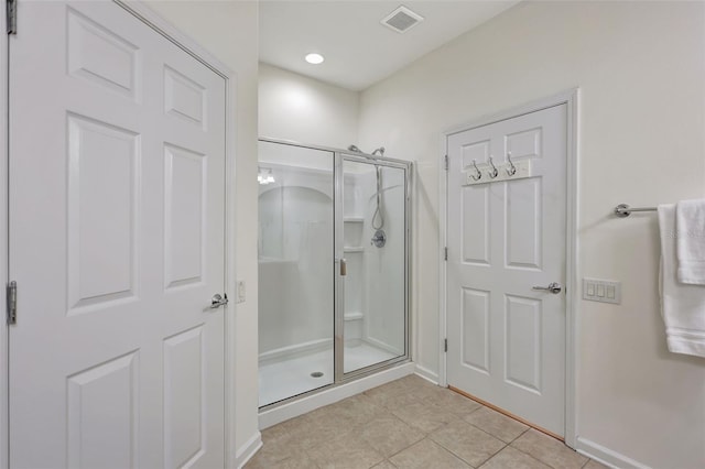 bathroom featuring visible vents, tile patterned floors, baseboards, and a stall shower