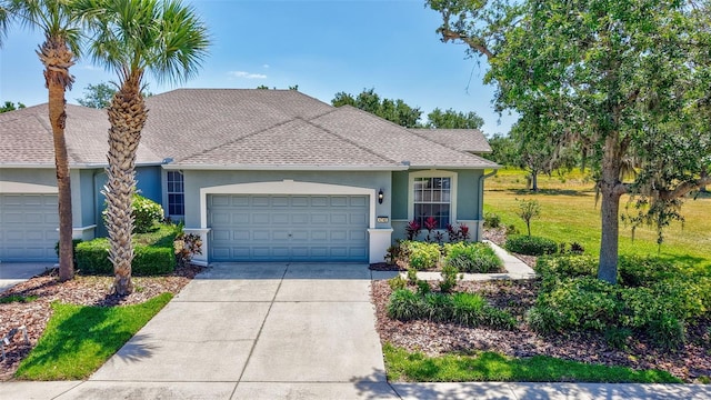 single story home with a garage, stucco siding, a shingled roof, and concrete driveway