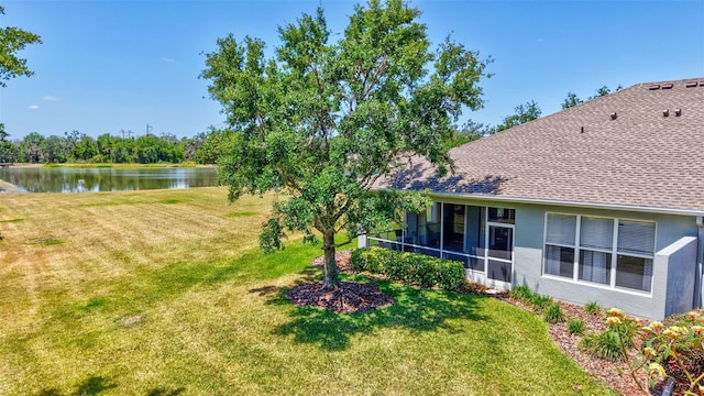 view of yard with a water view and a sunroom