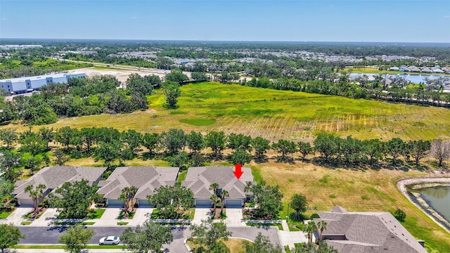 drone / aerial view featuring a residential view and a water view