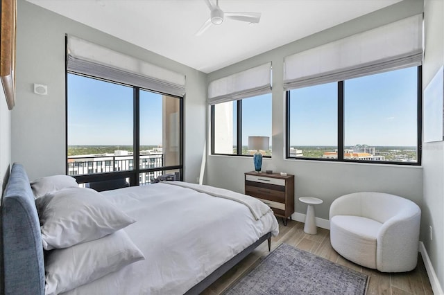 33 S Palm Ave Unit 1403, Sarasota, FL 34236 - bedroom with baseboards, multiple windows, and access to exterior
