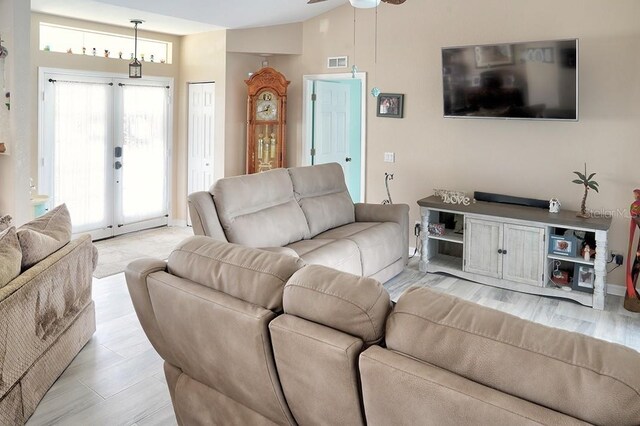 3984 Holin Ln, North Port, FL 34287 - living area with ceiling fan, french doors, light wood-style flooring, lofted ceiling, and visible vents