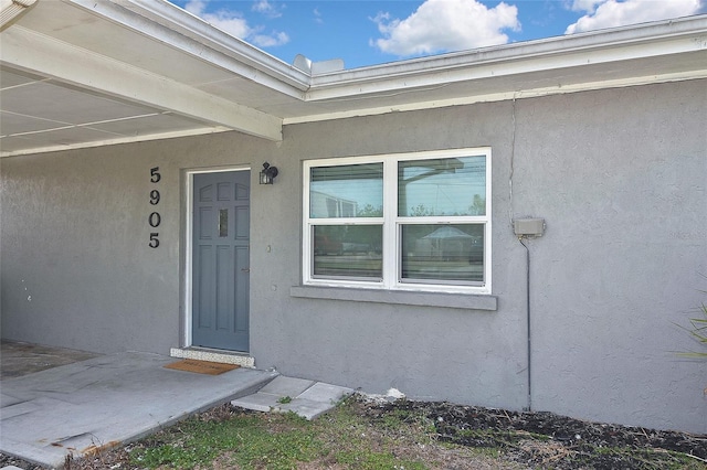 doorway to property with stucco siding