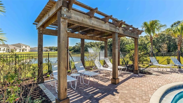 view of patio / terrace with a pergola, a water view, and a fenced backyard
