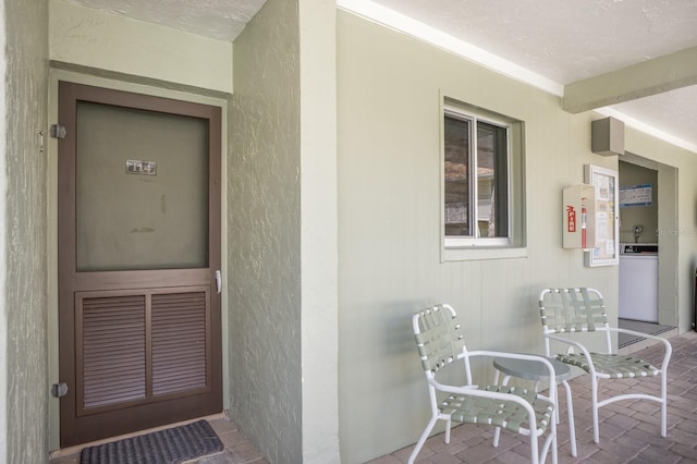 doorway to property featuring stucco siding