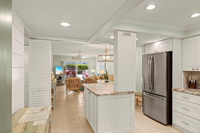 kitchen with freestanding refrigerator, recessed lighting, open floor plan, white cabinetry, and light tile patterned floors
