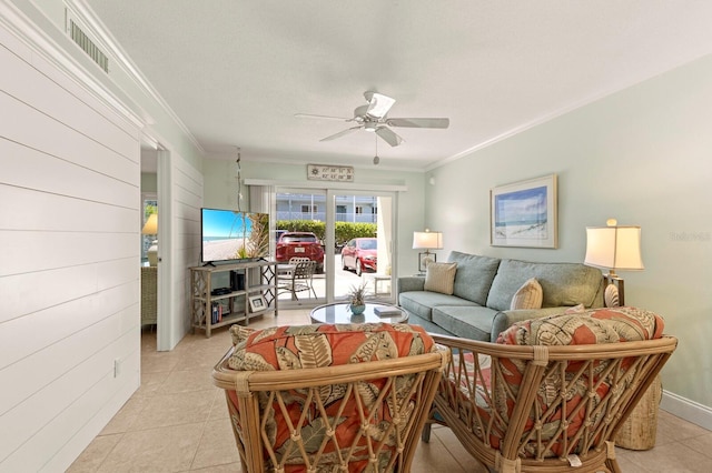 living room with ceiling fan, light tile patterned floors, and crown molding