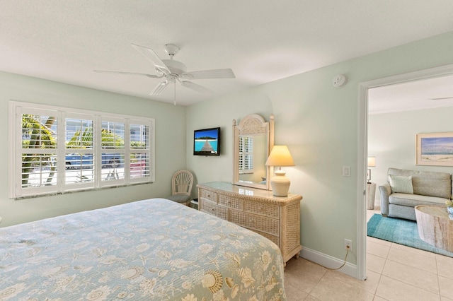 tiled bedroom with a ceiling fan and baseboards