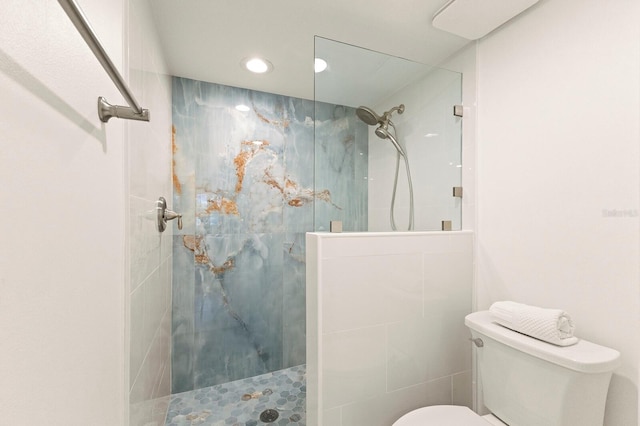 bathroom featuring a marble finish shower, toilet, and recessed lighting