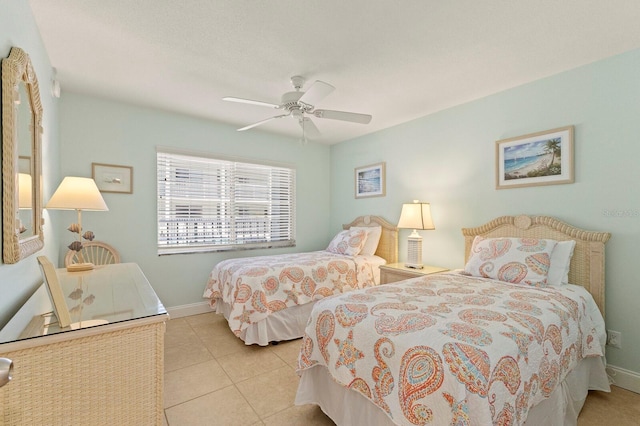 bedroom featuring tile patterned flooring, baseboards, and a ceiling fan