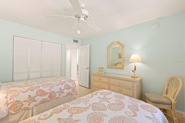 bedroom featuring a closet, a ceiling fan, and light tile patterned flooring
