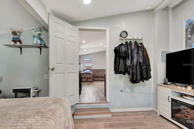 bedroom with light wood-style floors, recessed lighting, and vaulted ceiling