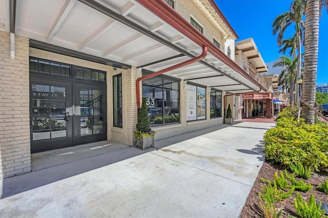 property entrance with french doors and brick siding