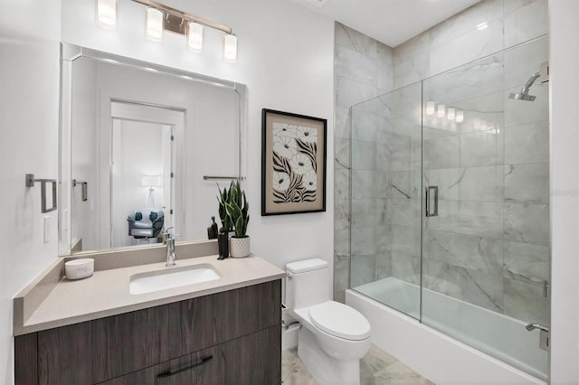 bathroom with toilet, vanity, and enclosed tub / shower combo