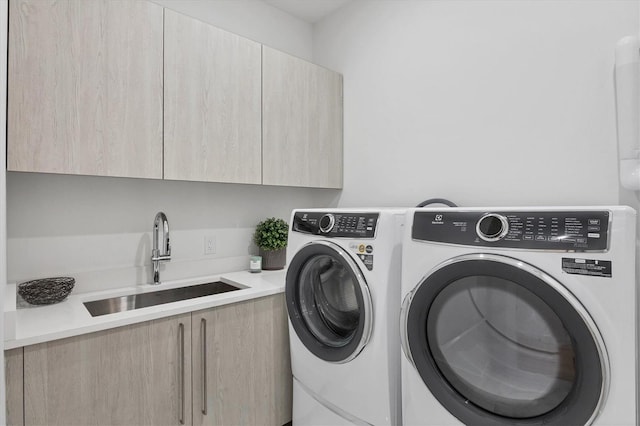 laundry area with cabinet space and independent washer and dryer