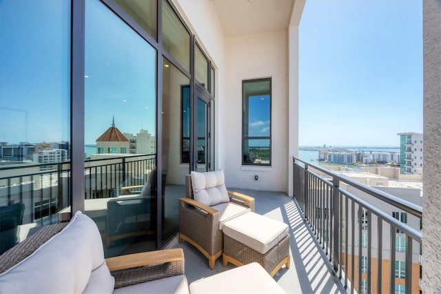 balcony featuring a city view and outdoor lounge area