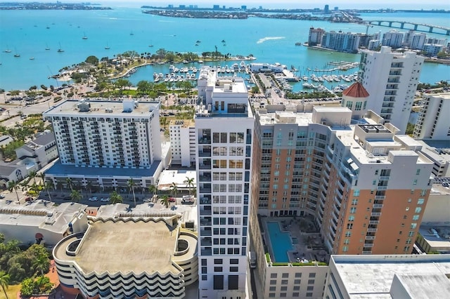 view of urban area with a nearby body of water, numerous boat docks, and a notable bridge